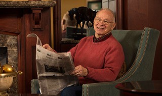 Resident reading the newspaper at the senior living community in Baltimore